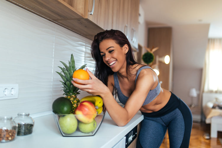young woman eating fruit for breakfast