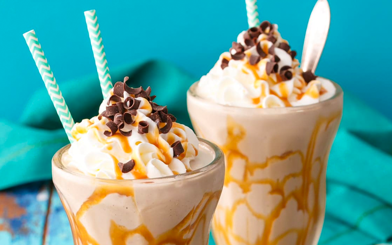 caramel cold brew shake topped with whipped cream and chocolate chip