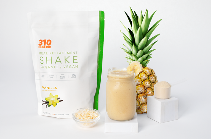 310 Vanilla shake, a glass of smoothie and whole pineapple