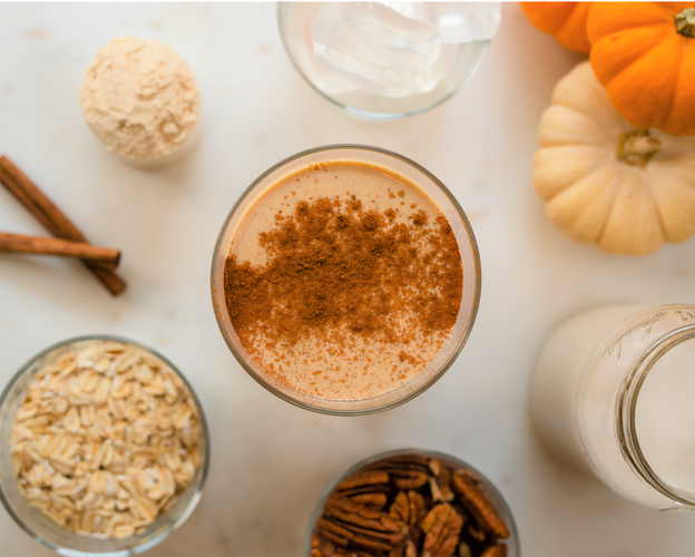 pumpkin spice oat milk latte in tall glass with ingredients