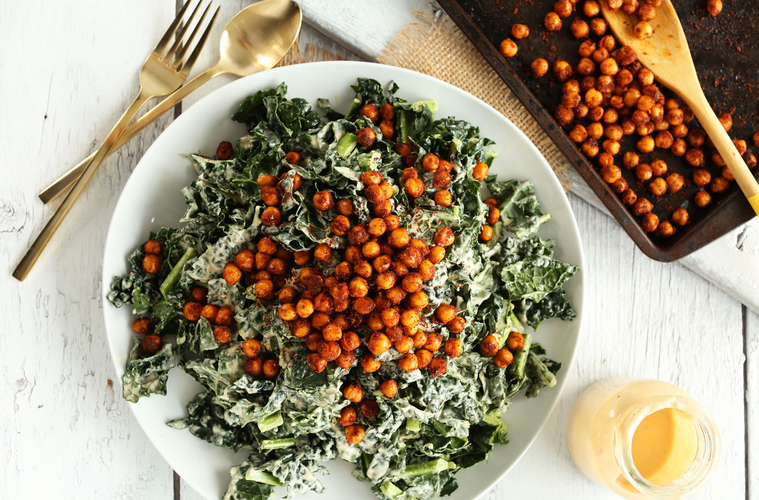 a plate of vegan kale salad and crispy peas