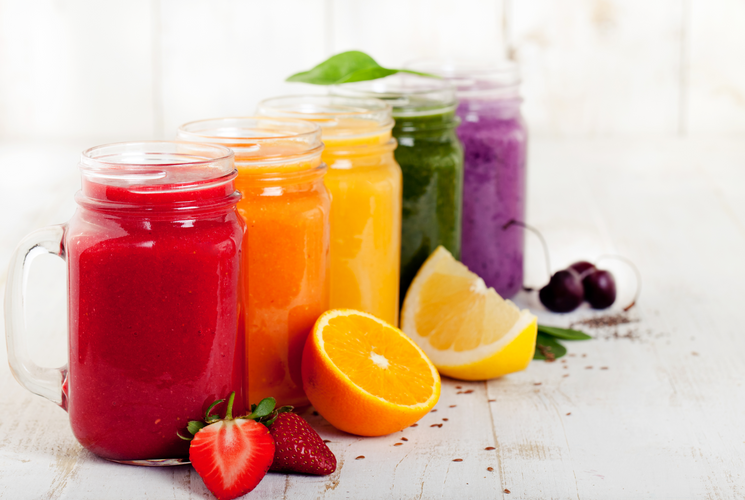 drinks variety with fresh fruits and berries on a white wooden background
