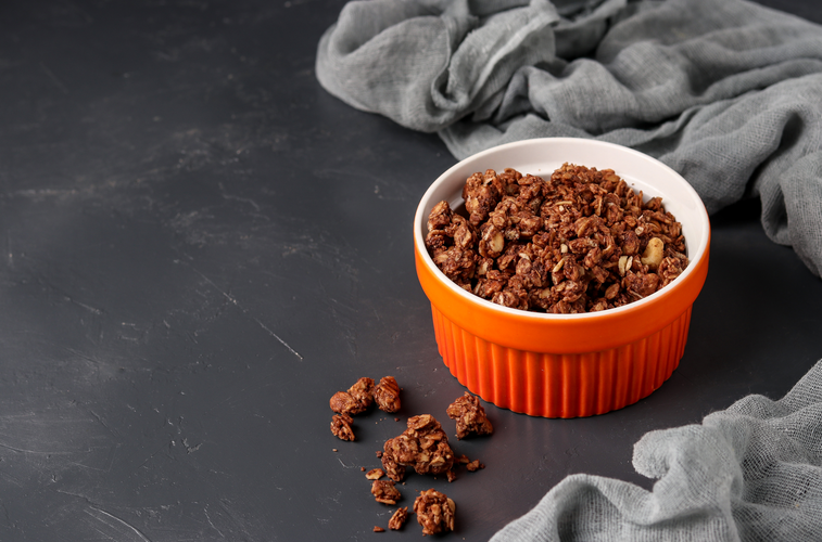 a bowl of granola on a black surface