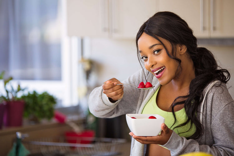 woman eating bowl of strawberries