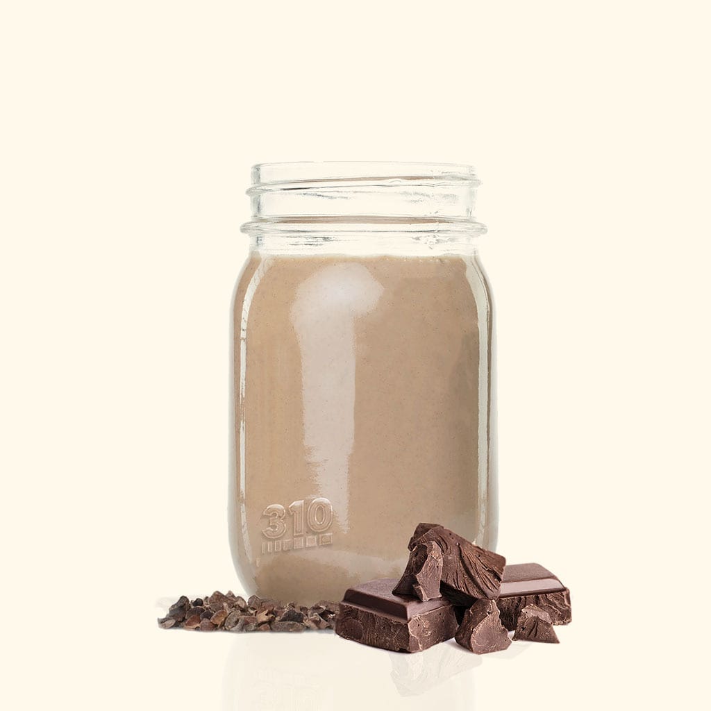 A 310 mason jar filled with a chocolate shake with chocolate pieces.
