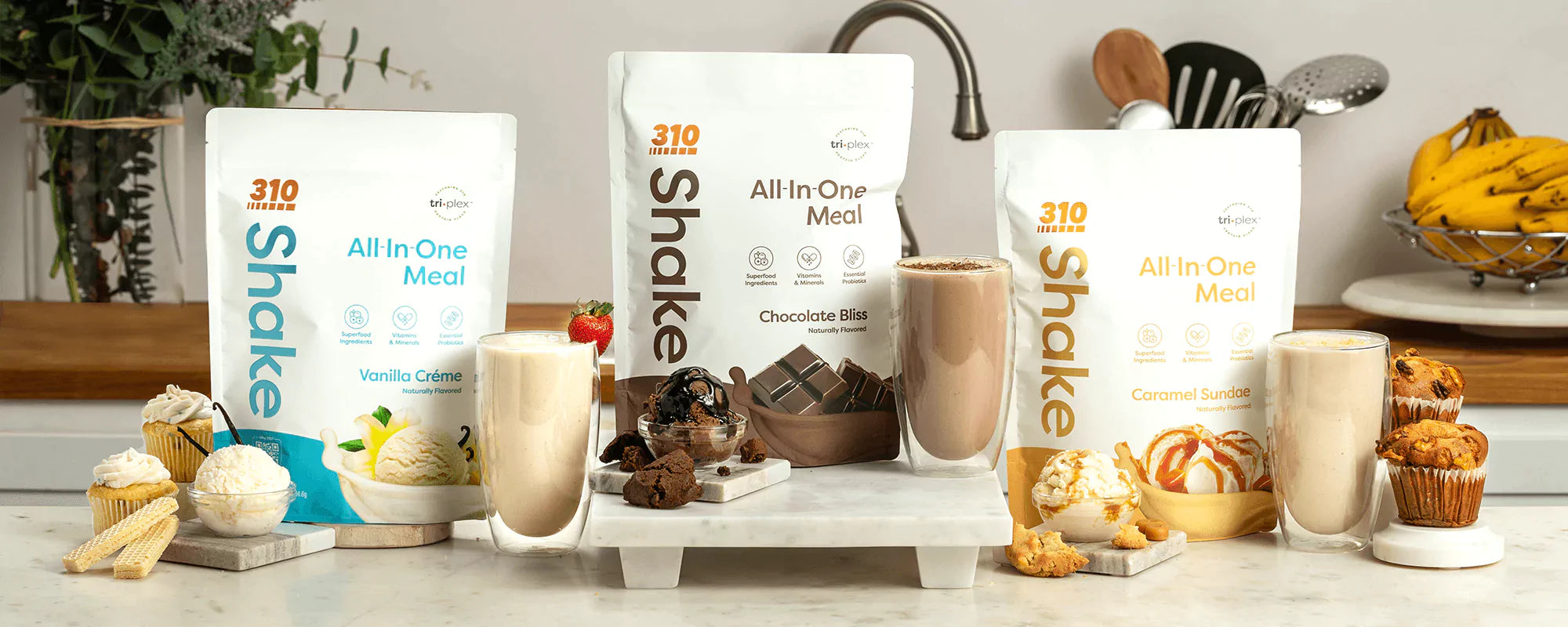 A display of 310 Shake Meal Replacement products in vanilla, chocolate, and caramel flavors.