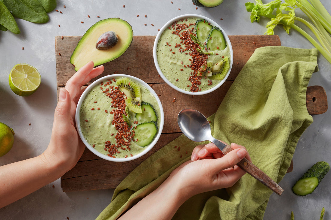 two bowls of avocado dessert in wooden board