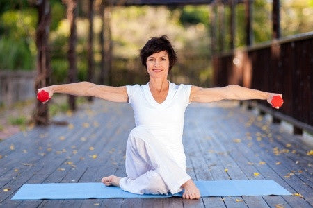 woman in all white attire doing yoga