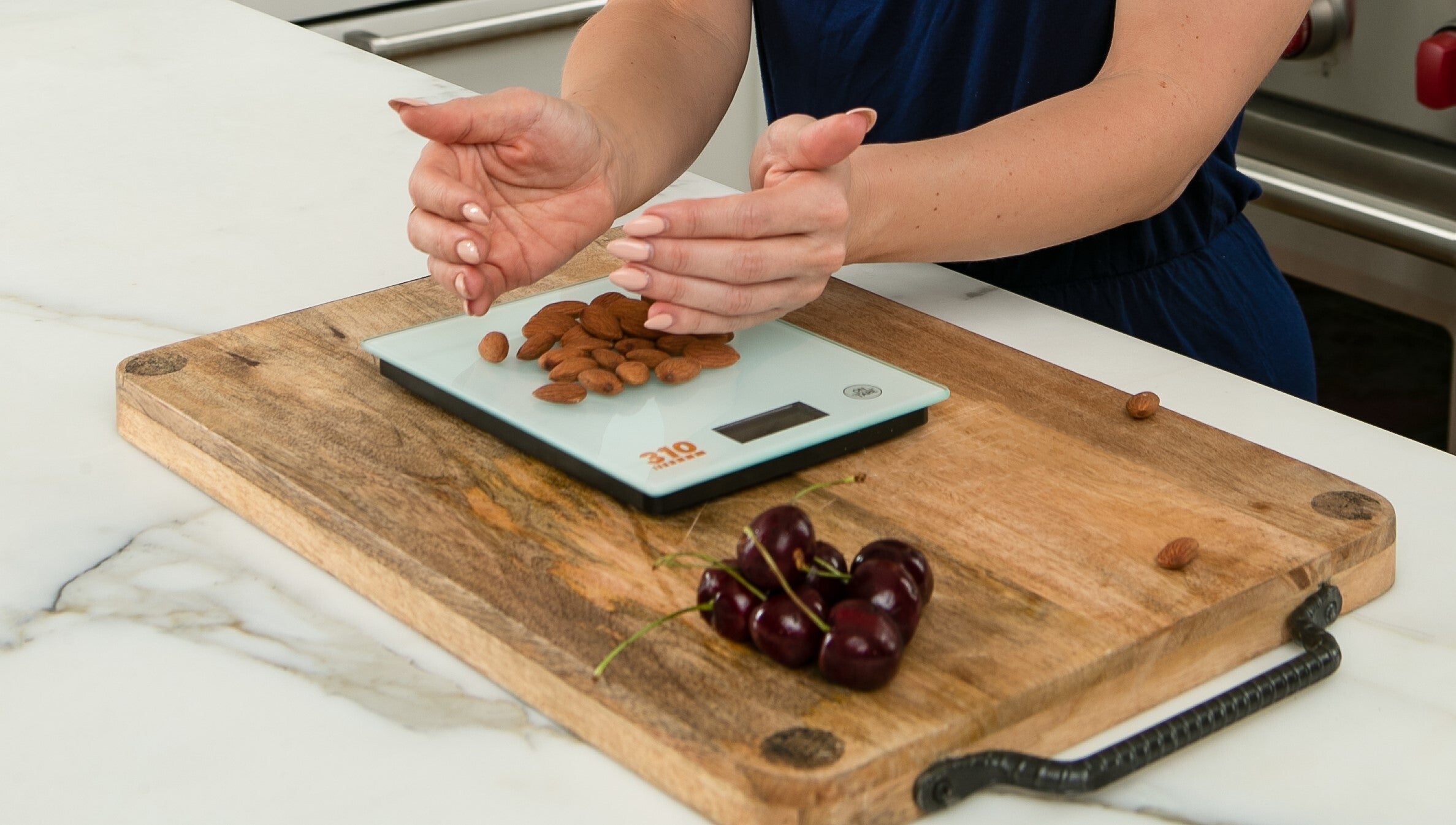 a wooden board and a digital scale in a marble counter top