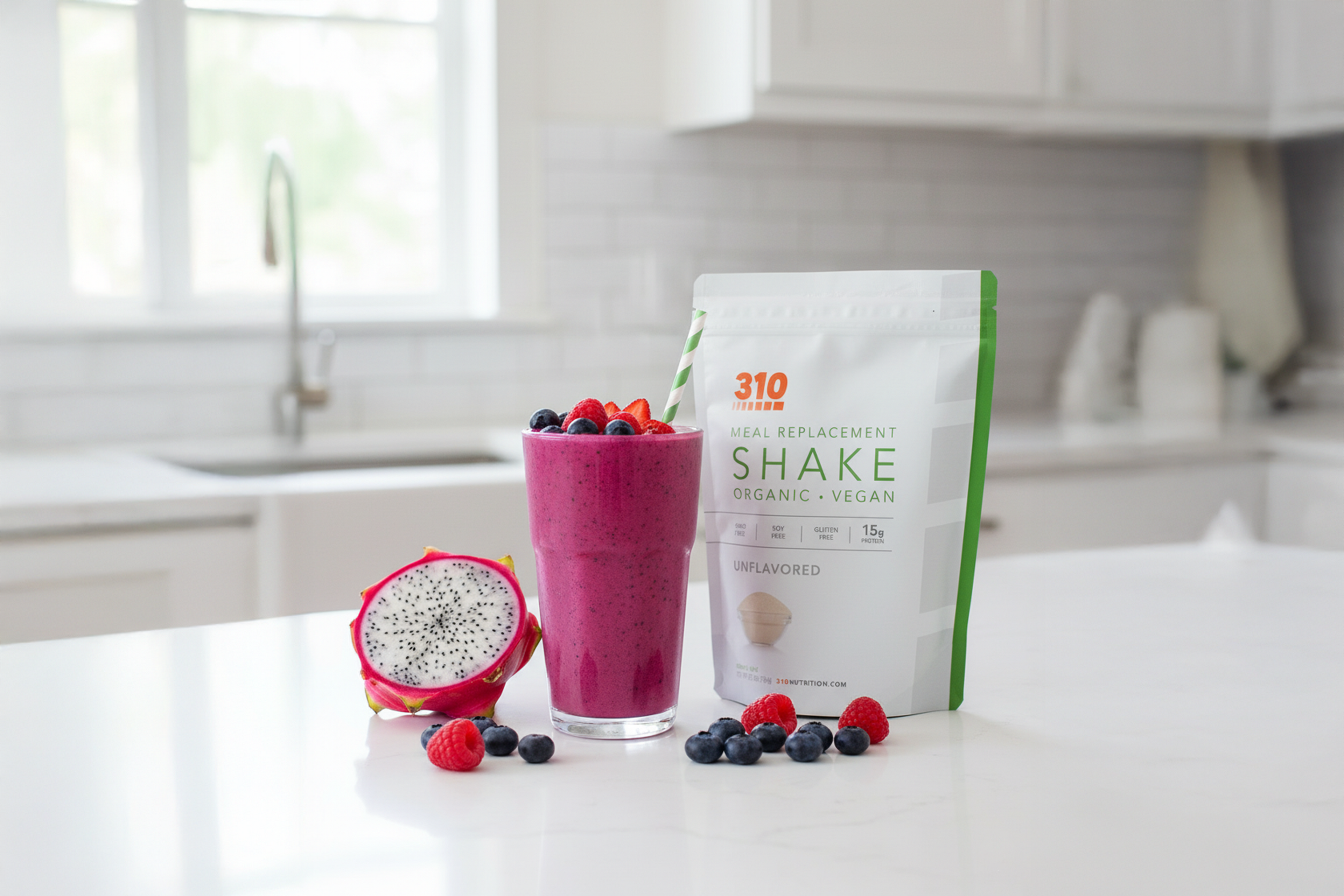 Glass of dragon fruit smoothie with 310 Shake pouch, fresh berries, and sliced dragon fruit.