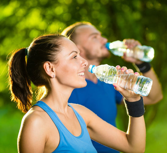 man and woman wearing blue top drinking water