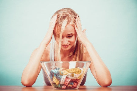 woman looking at the bowl with measuring tape