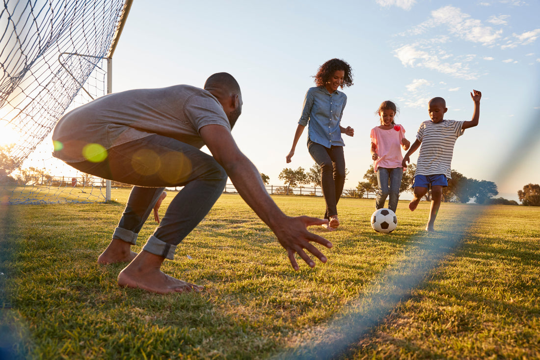 Family burning electrolytes in the heat playing soccer.