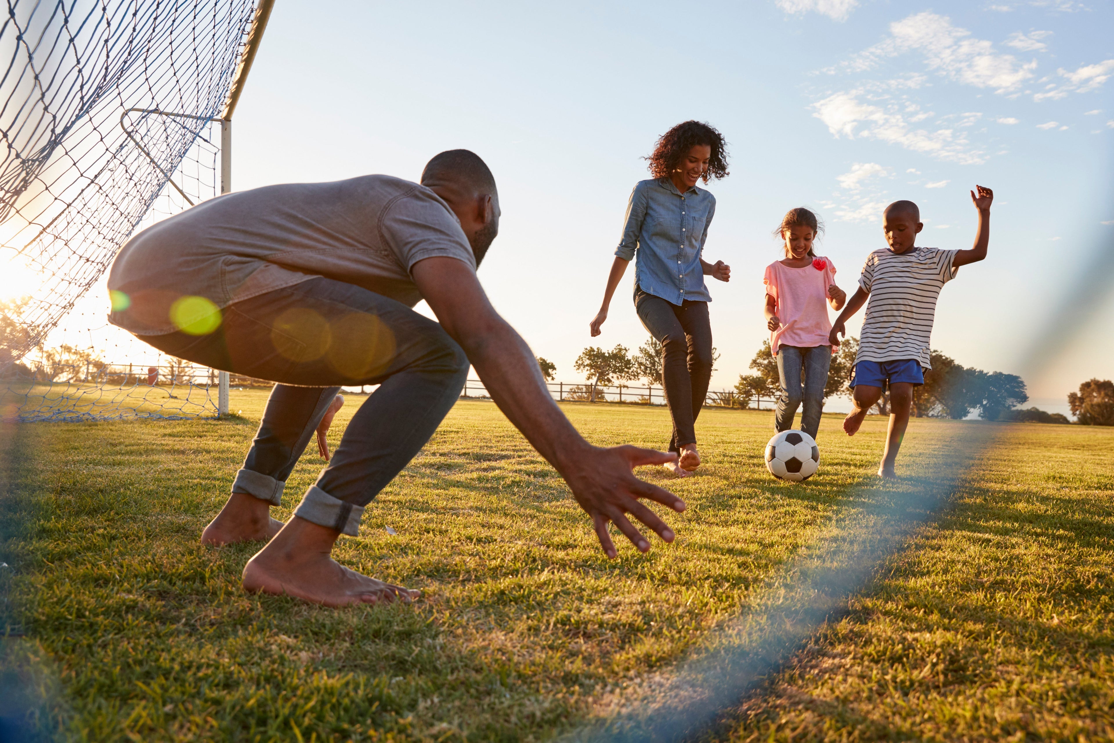 Family burning electrolytes in the heat playing soccer.