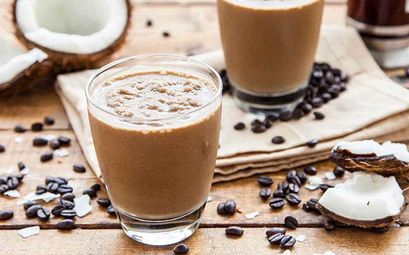 Coffee smoothie with coconut on dark grey backdrop