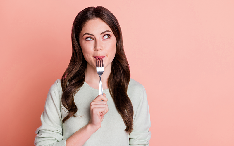 a woman with fork on her mouth