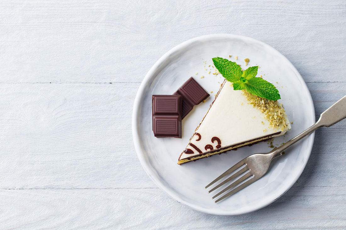 a plate with sliced cake and chocolate pieces