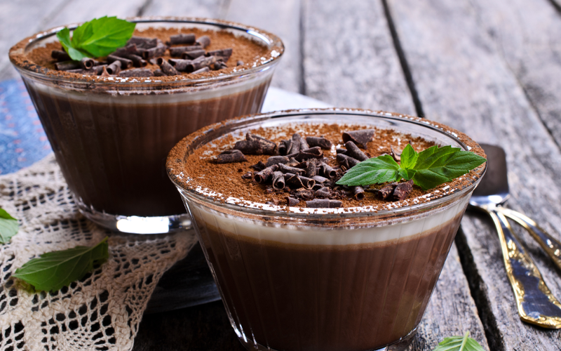 chocolate icing pudding topped with grated chocolate and mint