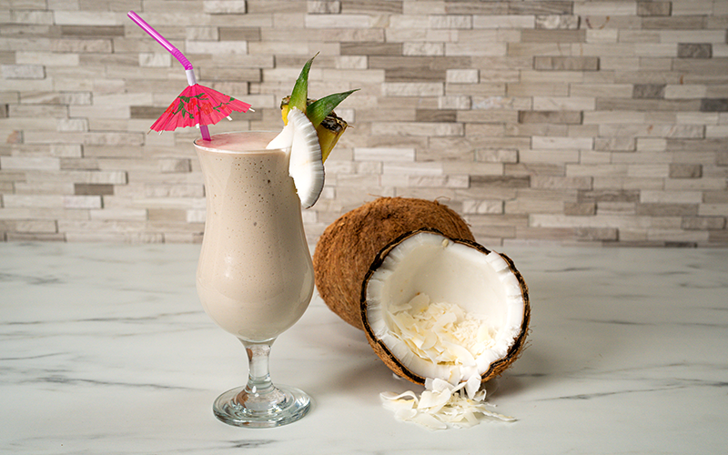 pina colada smoothie in glasses with pineapple