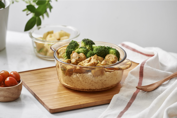 chicken and cauliflower rice bowl on a wooden board
