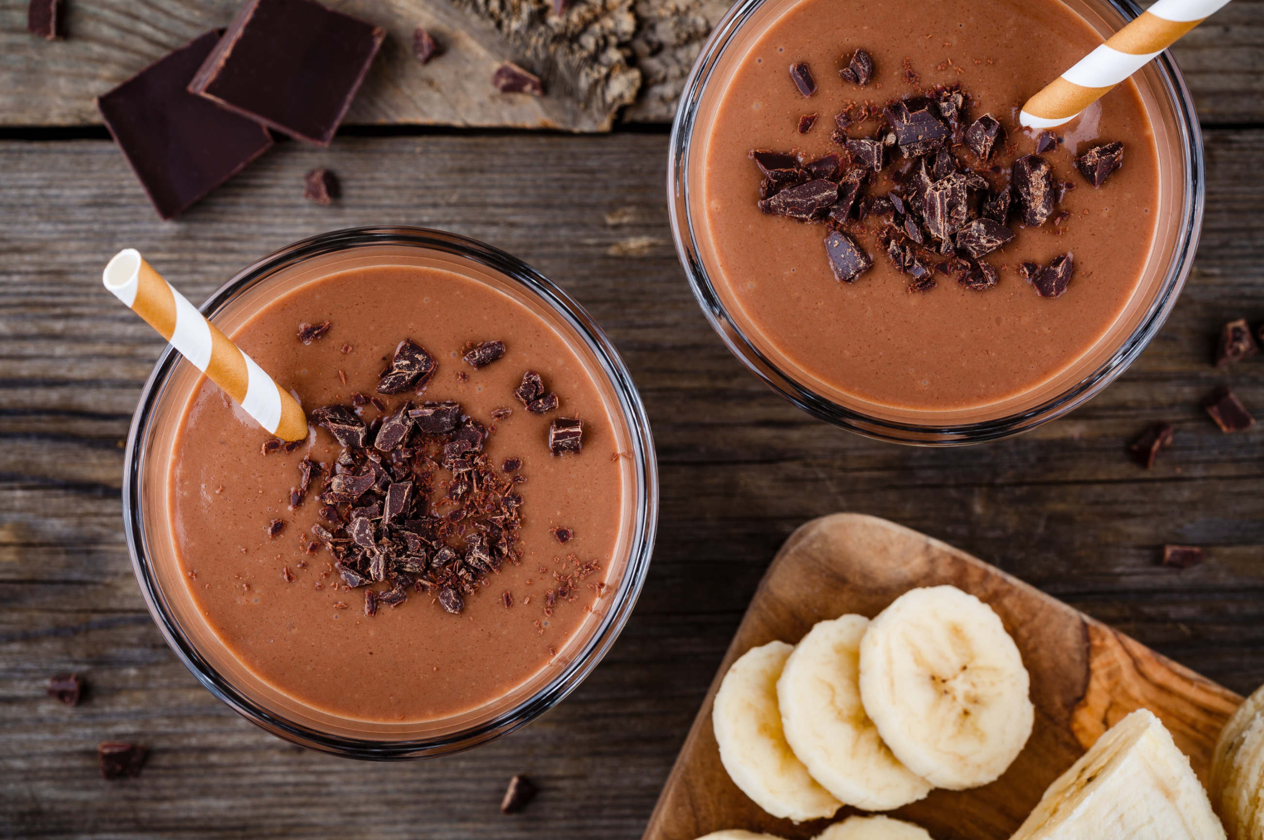 two glasses of mocha madness shake in a wooden board