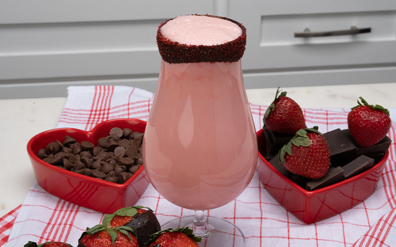 strawberry kiss shake and a heart-shaped bowl of chocolate and strawberries