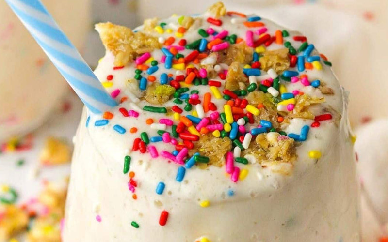 Glass with cold Vanilla milkshake with Vanilla beans