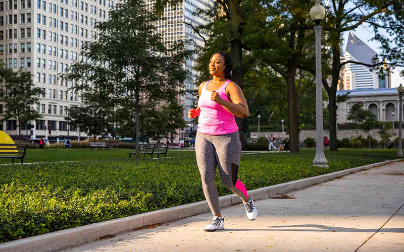 woman in pink tank top jogging at the park