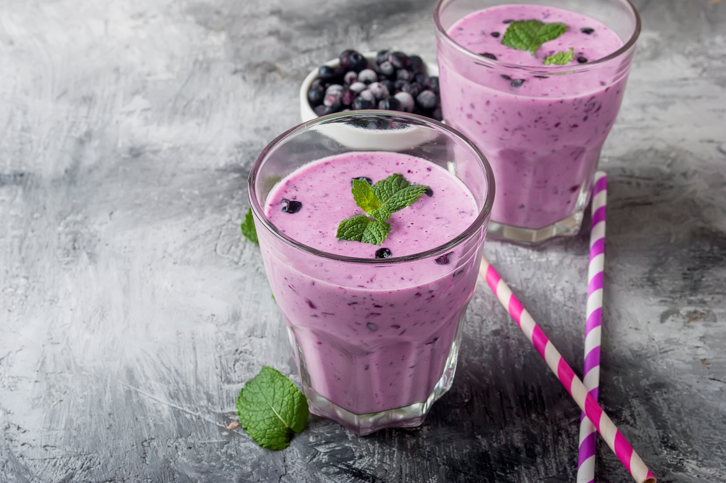 mixed berry shake with mint leaf and straws