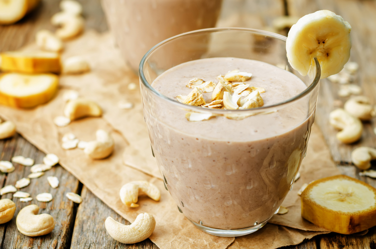 cashew banana cocoa oats smoothie on a wood background
