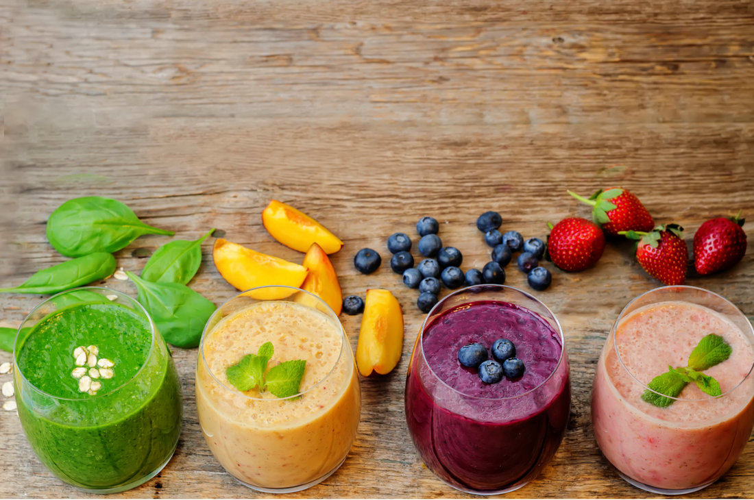 different flavors of smoothies on a wooden table