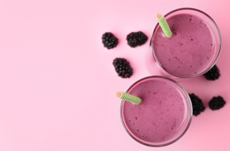 two glasses of blackberry lemon smoothie with green straw