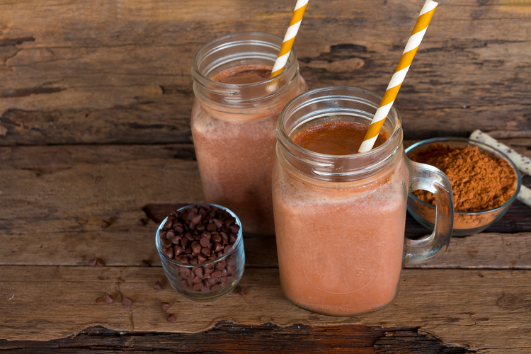 Chocolate and cocoa mixed with milk, smoothies on wooden floor