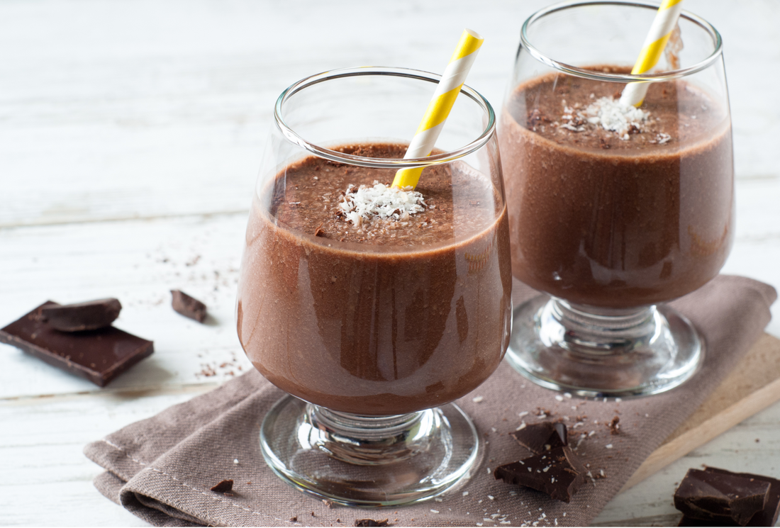 Chocolate smoothie with coconut on white wooden table