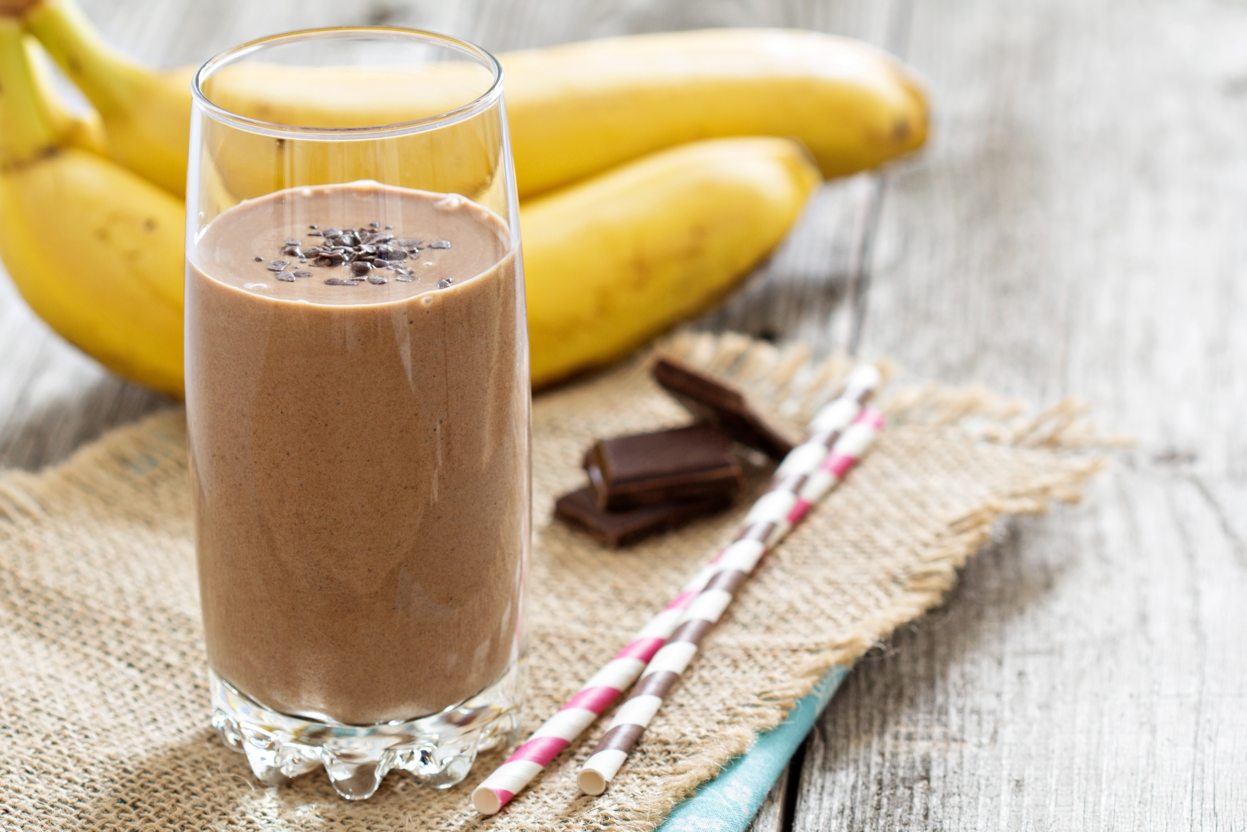 chocolate banana smoothie in glass with chia seeds