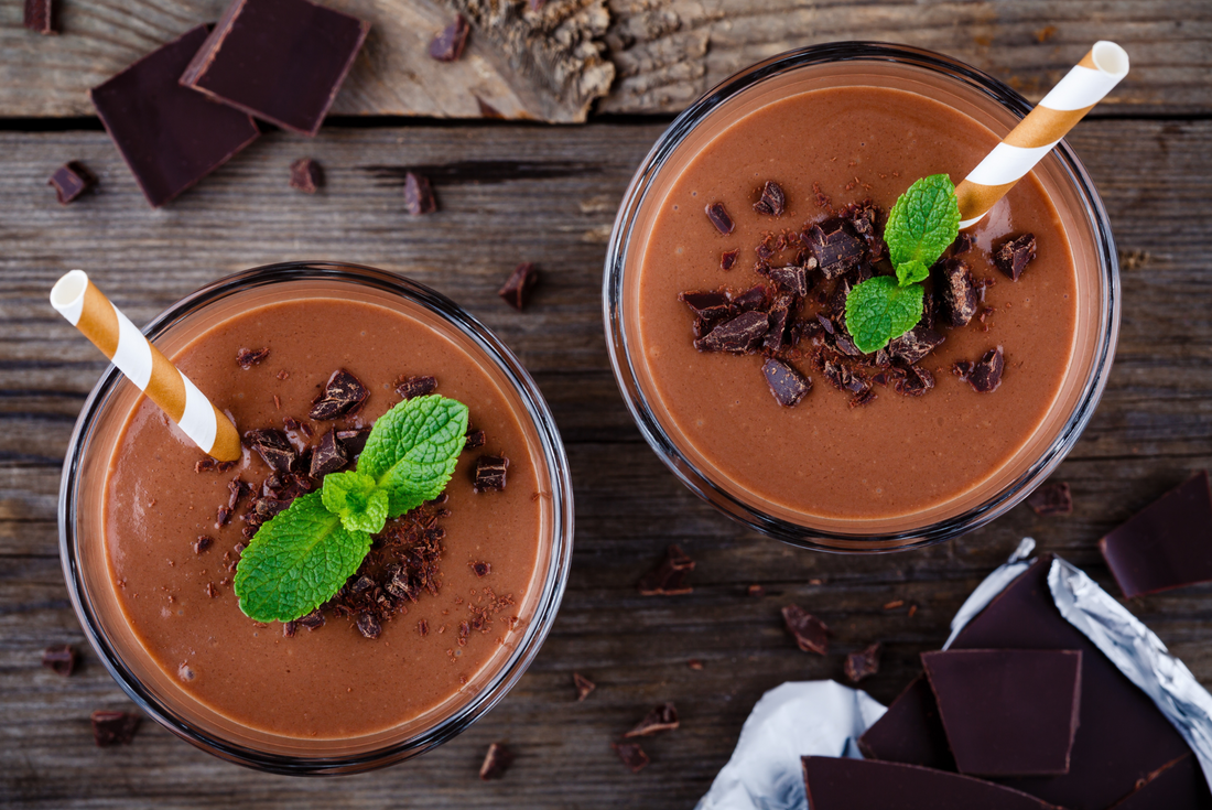 Chocolate smoothie with cacao nibs on rustic wooden background