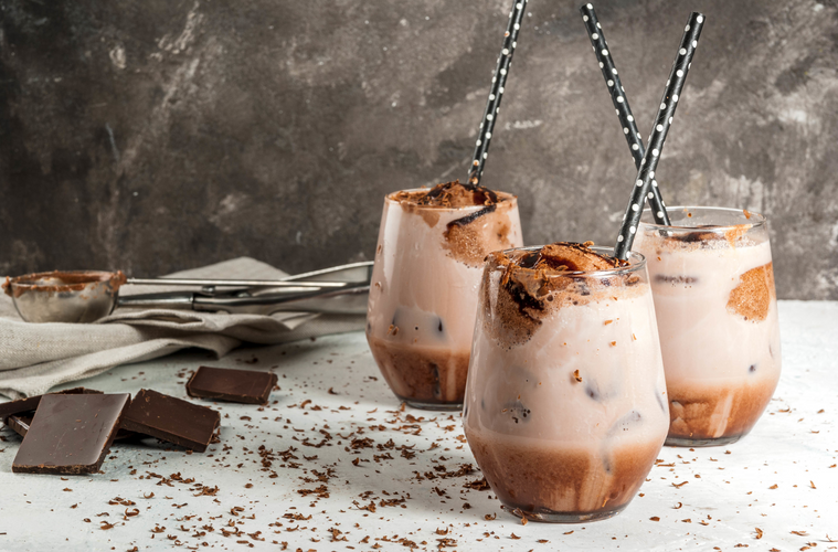 there glasses of chocolate s'mores frappe with a concrete background