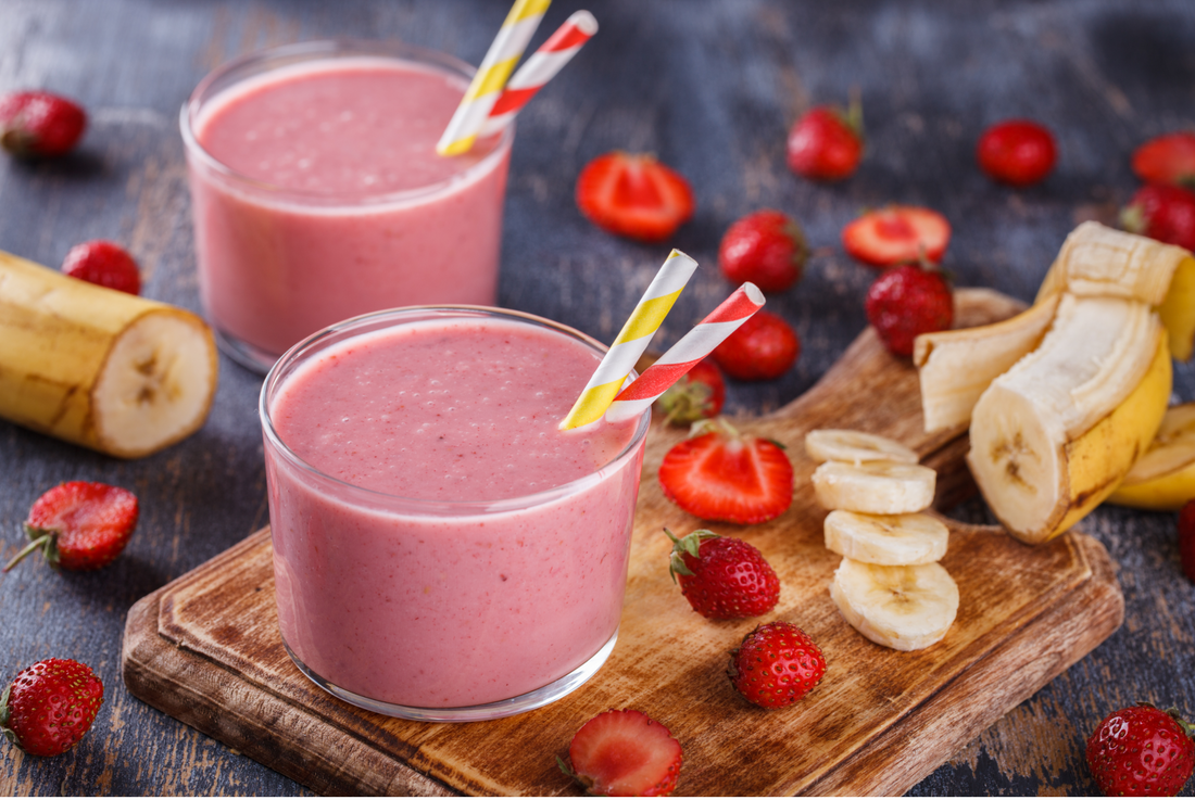 strawberry banana smoothie on wooden cutting board