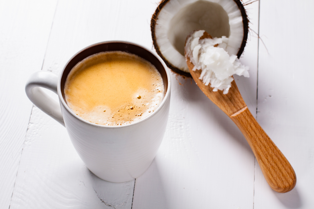 cup of coffee with spoonful of coconut oil