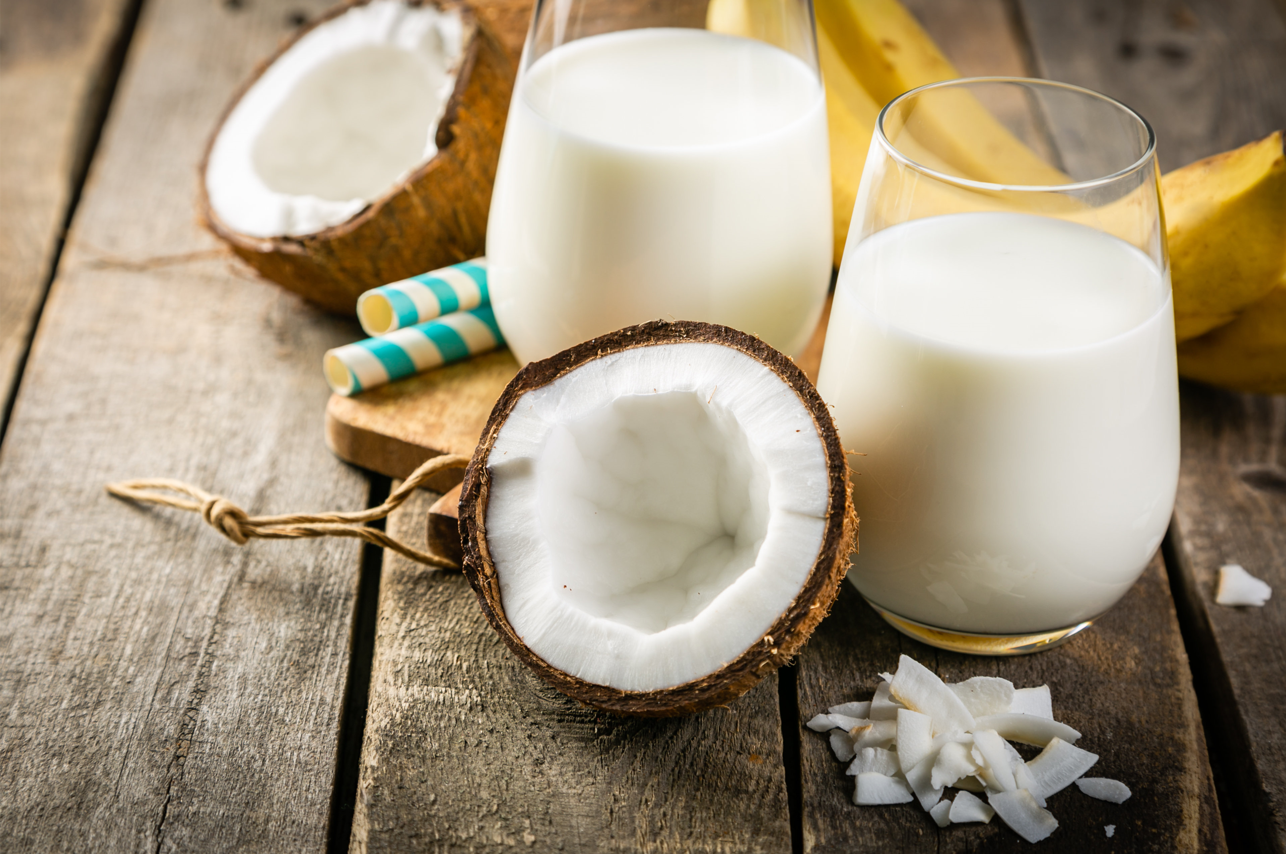 coco-nutty shake and half coconut on a wooden surface
