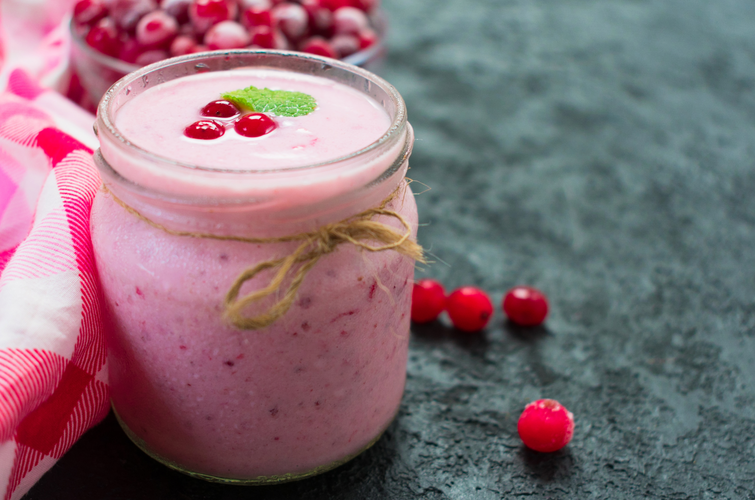 Healthy frozen cranberry yogurt on a black background