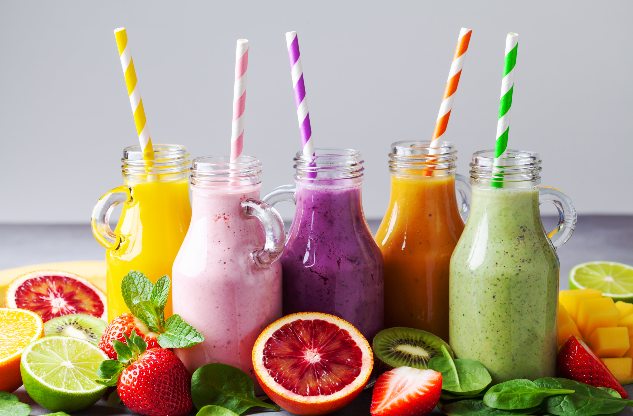 colorful meal replacement shake with fruits symbolizing their flavors