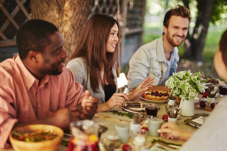 woman and men smiling in the table