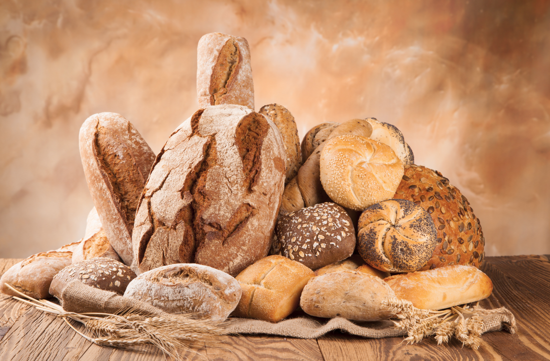 variety of different breads on wooden table