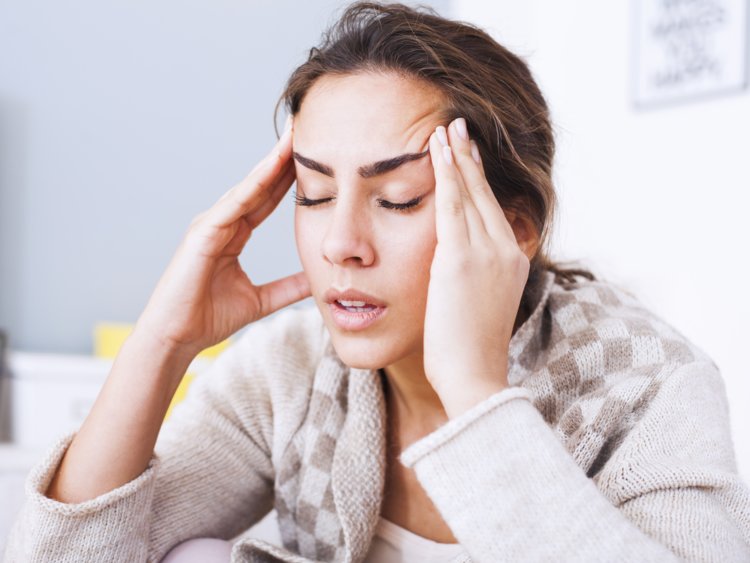  stressed woman with hand on her head
