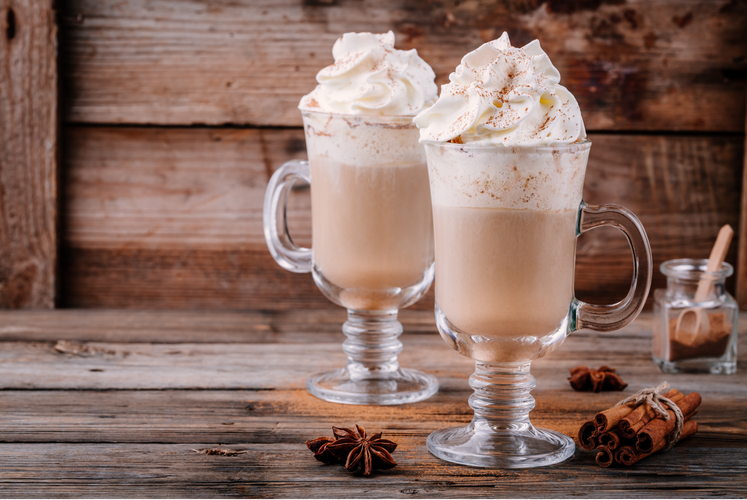 fresh cinnamon smoothie with whipped cream in glasses 