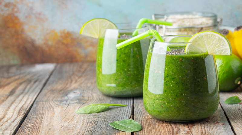 smoothie with lime, chia seeds, and spinach in glass jars