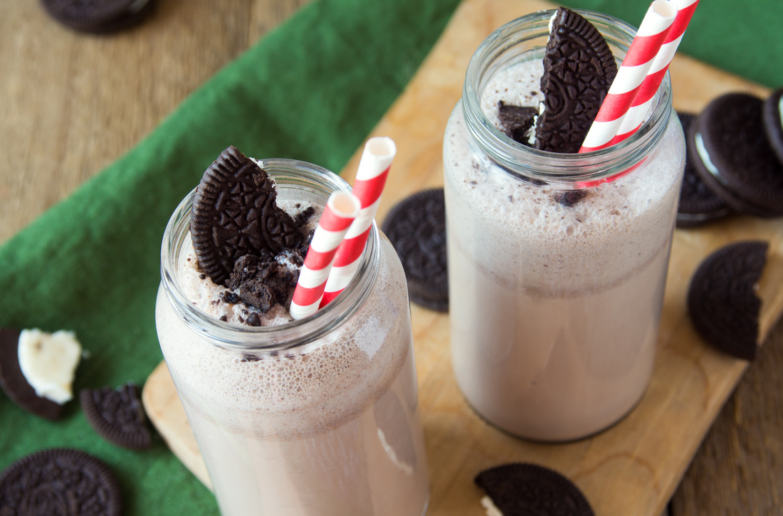 low-carb milk & cookies shake topped with cookies on a wooden board