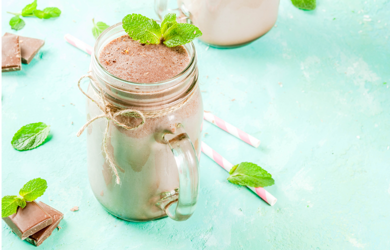 chocolate mint shake in mason jar on blue background
