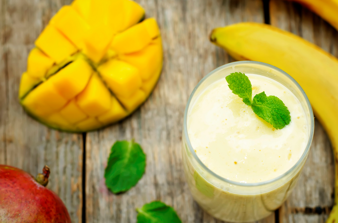 banana mango smoothie on a dark wood background